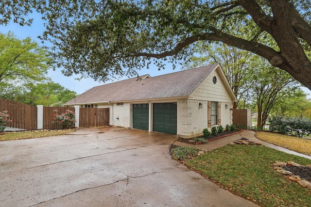 single story home with roof with shingles, driveway, brick siding, a garage, and fence