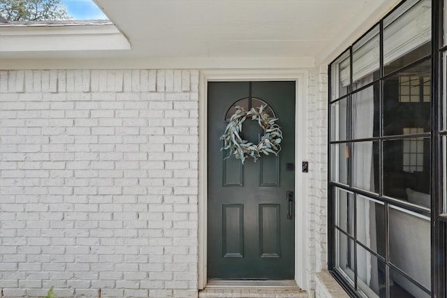 property entrance with brick siding