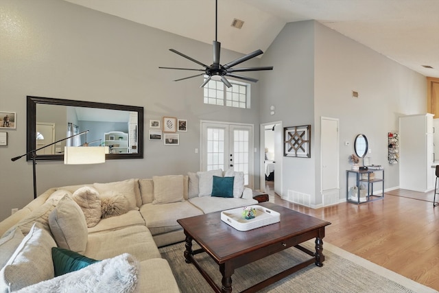 living room with visible vents, baseboards, ceiling fan, wood finished floors, and french doors