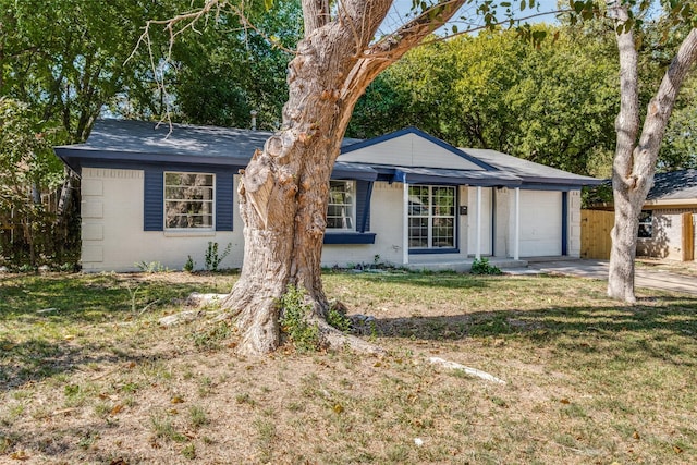 3945 Happy Canyon Dr, Dallas, TX 75241 - ranch-style house with an attached garage, concrete driveway, brick siding, and a front yard