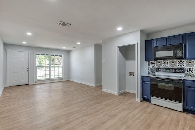 3945 Happy Canyon Dr, Dallas, TX 75241 - kitchen featuring light countertops, light wood-style floors, backsplash, black microwave, and electric range