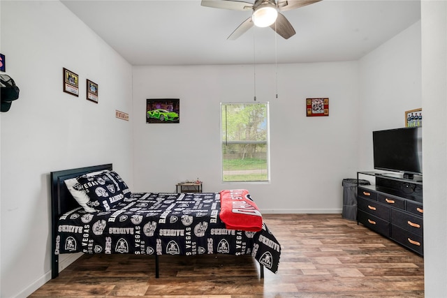 bedroom with wood finished floors, ceiling fan, and baseboards