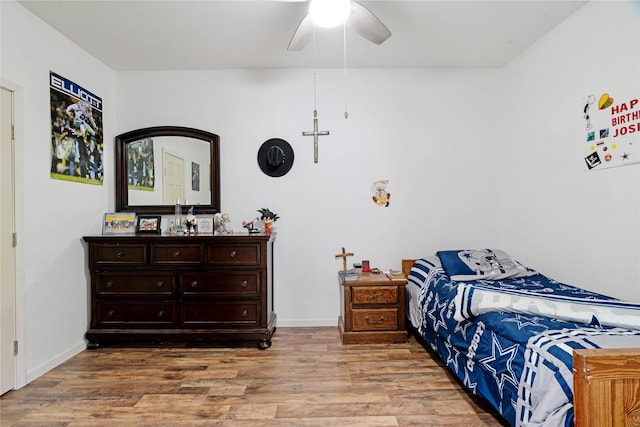 bedroom featuring baseboards, a ceiling fan, and light wood-style floors