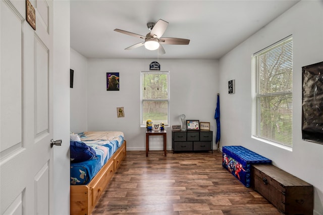 bedroom featuring wood finished floors, ceiling fan, and baseboards