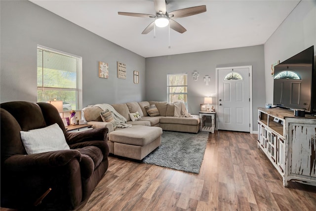 living room featuring wood finished floors and a ceiling fan