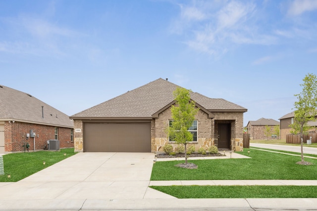 1002 Honey Maple St, Princeton, TX 75407 - view of front facade featuring a garage, roof with shingles, driveway, a front lawn, and stone siding