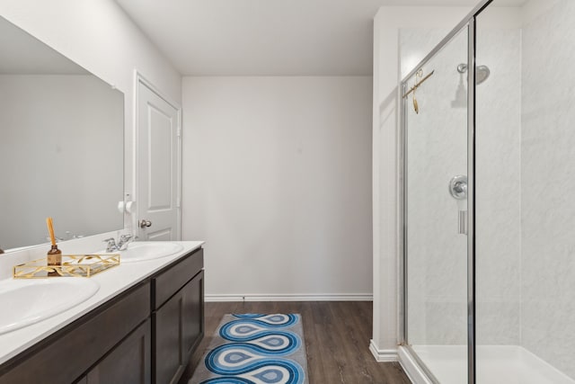 1002 Honey Maple St, Princeton, TX 75407 - bathroom featuring wood finished floors, a shower stall, and double vanity