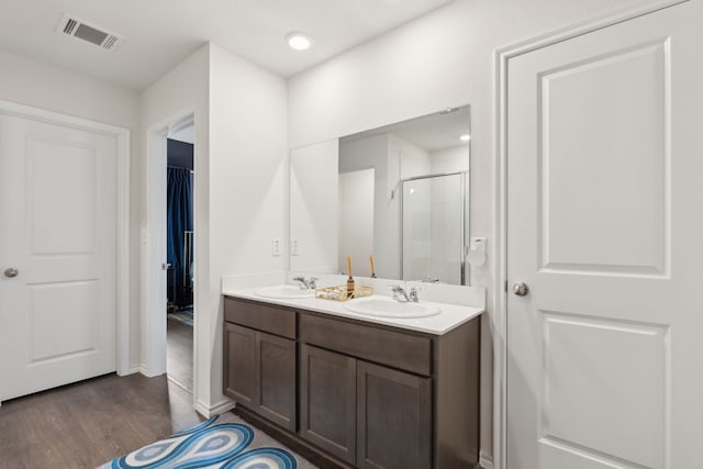 1002 Honey Maple St, Princeton, TX 75407 - bathroom featuring a stall shower, wood finished floors, and double vanity