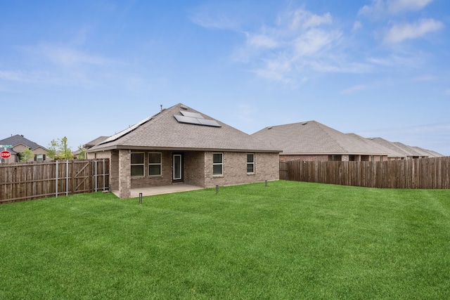1002 Honey Maple St, Princeton, TX 75407 - back of property with roof mounted solar panels, a patio, brick siding, and a shingled roof