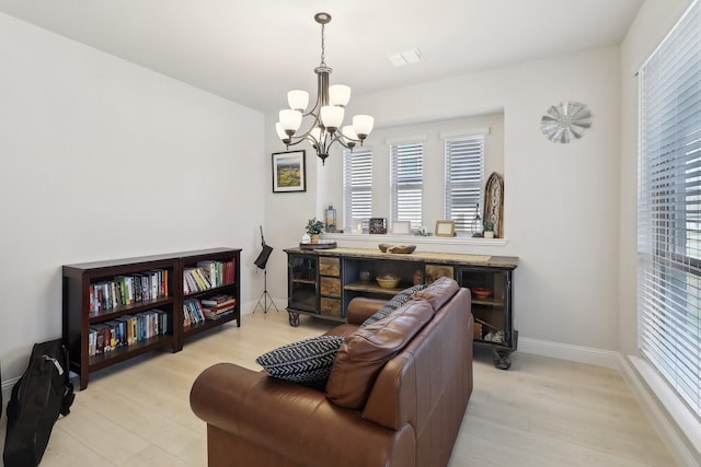 1103 Wrenwood Dr, Justin, TX 76247 - living room featuring a chandelier, light wood finished floors, and baseboards