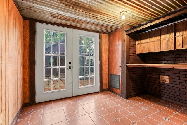 7220 Amy St, Dallas, TX 75217 - entryway featuring wood walls, french doors, wooden ceiling, and brick wall