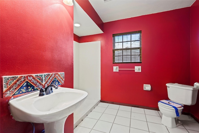 7220 Amy St, Dallas, TX 75217 - bathroom featuring tile patterned floors, toilet, baseboards, and a sink