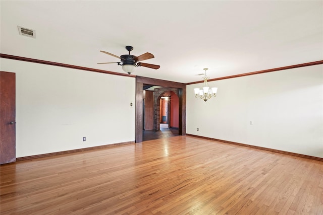 7220 Amy St, Dallas, TX 75217 - empty room featuring ornamental molding, ceiling fan with notable chandelier, arched walkways, light wood-style floors, and visible vents