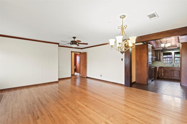 7220 Amy St, Dallas, TX 75217 - unfurnished living room with baseboards, visible vents, wood finished floors, and a sink