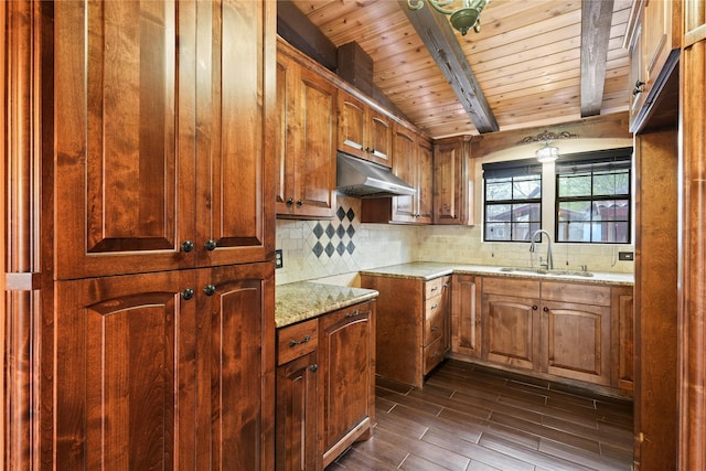 7220 Amy St, Dallas, TX 75217 - kitchen featuring under cabinet range hood, backsplash, a sink, beamed ceiling, and light stone counters