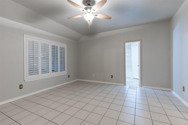 unfurnished room featuring lofted ceiling, baseboards, light tile patterned flooring, and ceiling fan