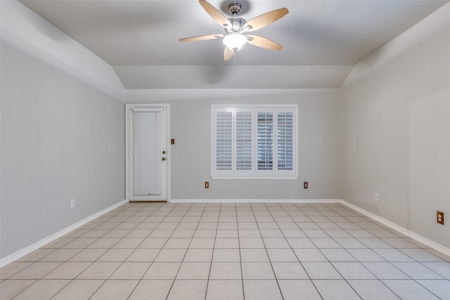 spare room with baseboards, a ceiling fan, and vaulted ceiling