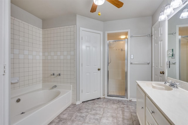 bathroom with tile patterned flooring, vanity, a stall shower, and ceiling fan