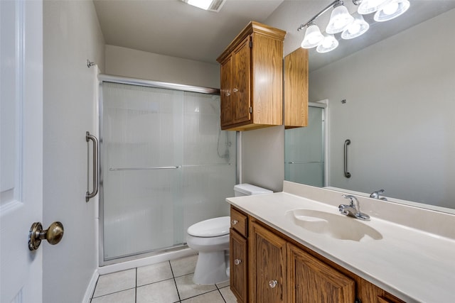 full bath featuring toilet, a stall shower, vanity, and tile patterned flooring