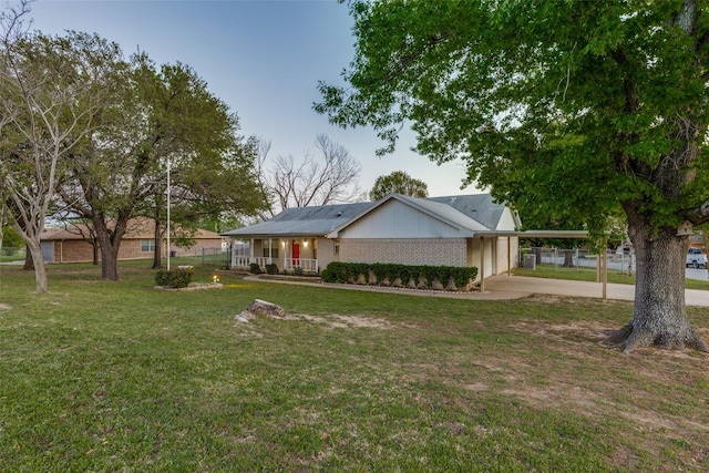 ranch-style home with a front lawn, an attached garage, and driveway