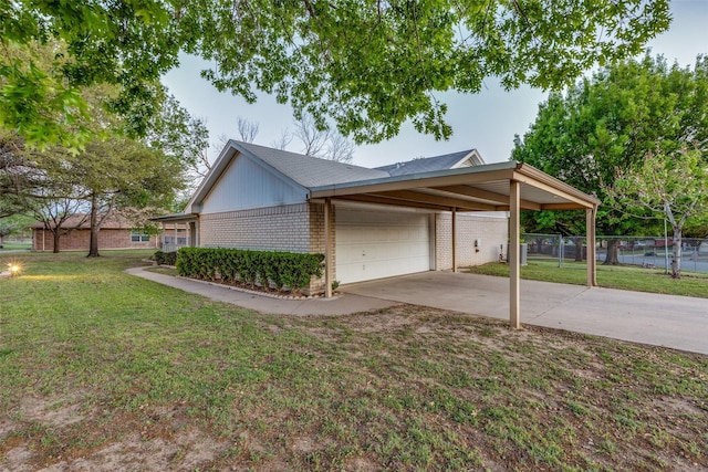 view of home's exterior featuring a garage, a lawn, fence, brick siding, and concrete driveway