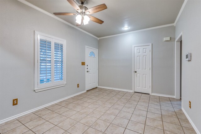 interior space with ornamental molding, baseboards, a ceiling fan, and light tile patterned flooring
