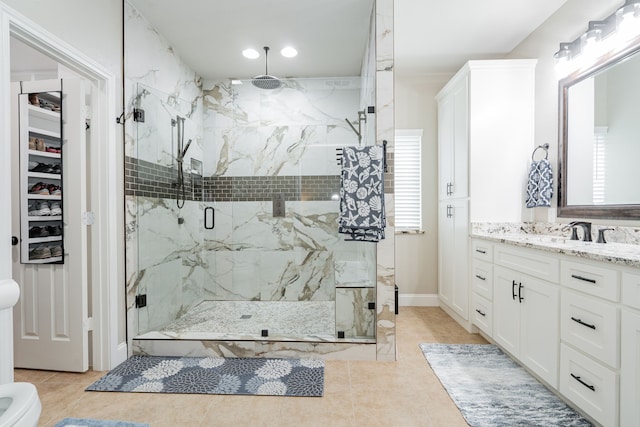 1609 W Alamosa Dr, Talty, TX 75160 - bathroom featuring a marble finish shower, vanity, tile patterned flooring, and recessed lighting