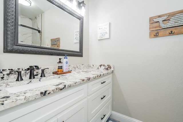 1609 W Alamosa Dr, Talty, TX 75160 - bathroom with vanity, baseboards, and a shower