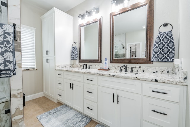 1609 W Alamosa Dr, Talty, TX 75160 - full bathroom with double vanity, a shower, tile patterned floors, and baseboards