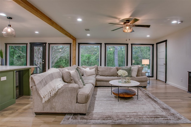living room featuring beam ceiling, light wood-style flooring, visible vents, ceiling fan, and recessed lighting