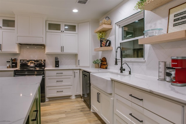kitchen featuring white cabinets, a sink, black appliances, and open shelves