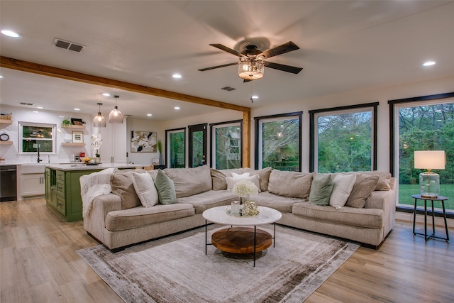 living room with beam ceiling, a ceiling fan, light wood finished floors, visible vents, and recessed lighting