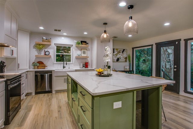 kitchen with dishwasher, black electric range oven, a sink, green cabinetry, and open shelves