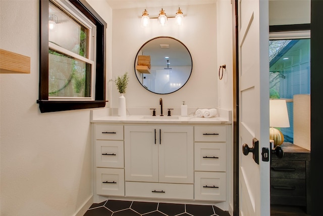 bathroom featuring tile patterned flooring, vanity, and baseboards