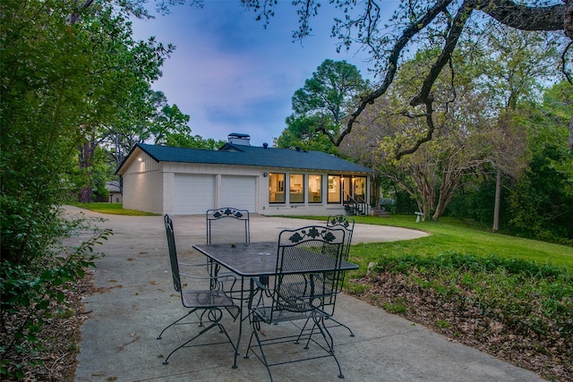 view of patio featuring driveway and an attached garage