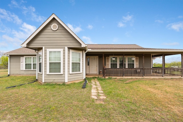 view of front of property featuring a porch, a shingled roof, and a front lawn