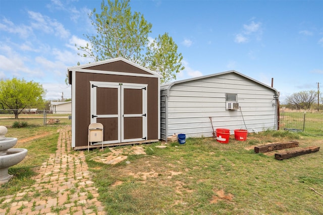 view of shed with cooling unit and fence