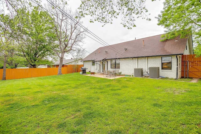 3113 Westfield Ave, Fort Worth, TX 76133 - rear view of property featuring central AC unit, a patio area, brick siding, and a yard