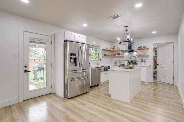 3113 Westfield Ave, Fort Worth, TX 76133 - kitchen featuring open shelves, stainless steel appliances, visible vents, wall chimney range hood, and light wood-style flooring