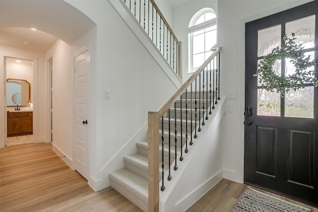 1512 Trailblazer Way, Northlake, TX 76247 - foyer entrance with arched walkways, light wood-type flooring, stairs, and baseboards