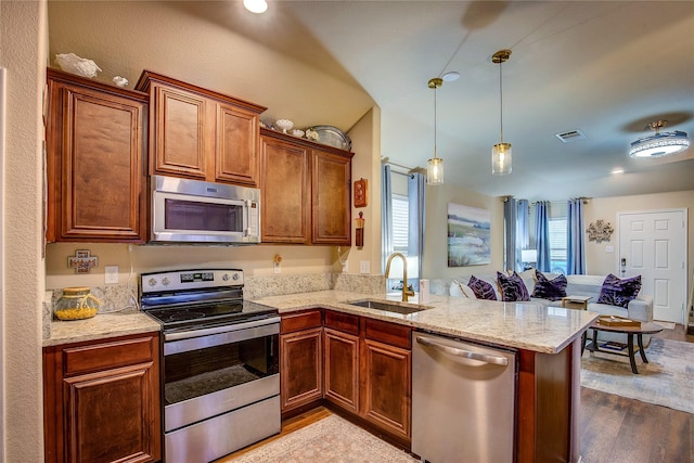 4036 Eagle Dr, Forney, TX 75126 - kitchen featuring visible vents, a peninsula, light stone countertops, appliances with stainless steel finishes, and a sink