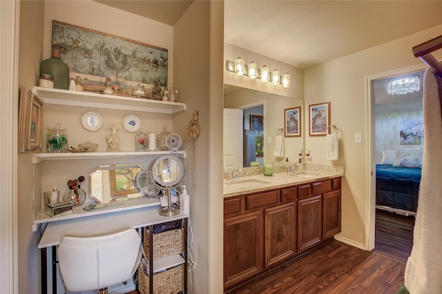 4036 Eagle Dr, Forney, TX 75126 - ensuite bathroom with double vanity, a sink, baseboards, and wood finished floors