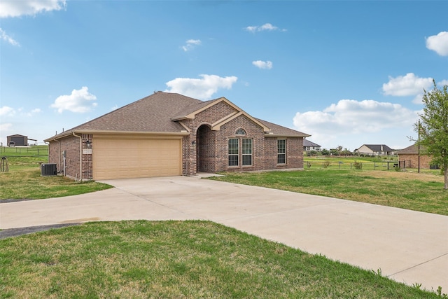 7203 Veal Station Rd, Weatherford, TX 76085 - view of front facade with fence, a garage, a front yard, brick siding, and central AC
