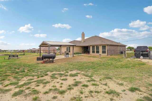 7203 Veal Station Rd, Weatherford, TX 76085 - back of house with a gate, fence, a chimney, a gazebo, and a yard