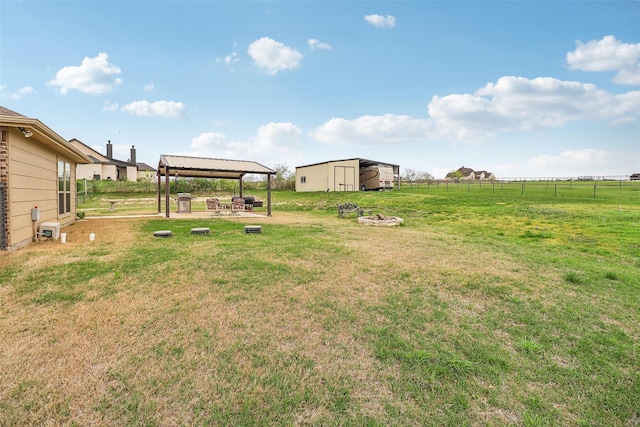 7203 Veal Station Rd, Weatherford, TX 76085 - view of yard featuring an outdoor structure, an outbuilding, fence, a gazebo, and a fire pit