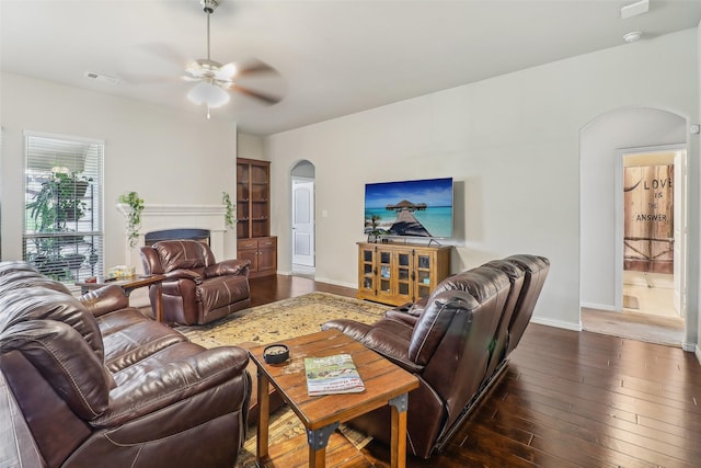 7203 Veal Station Rd, Weatherford, TX 76085 - living area featuring baseboards, arched walkways, hardwood / wood-style flooring, visible vents, and a ceiling fan