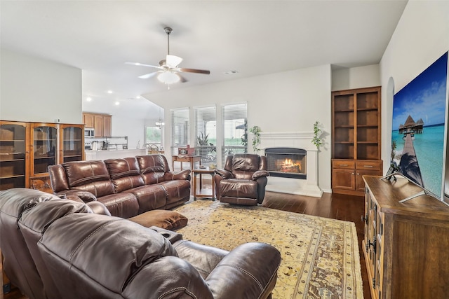 7203 Veal Station Rd, Weatherford, TX 76085 - living area featuring a warm lit fireplace, dark wood-style flooring, ceiling fan, and visible vents