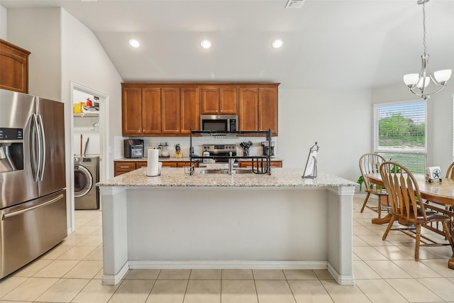 7203 Veal Station Rd, Weatherford, TX 76085 - kitchen featuring lofted ceiling, decorative backsplash, washer / clothes dryer, a notable chandelier, and appliances with stainless steel finishes