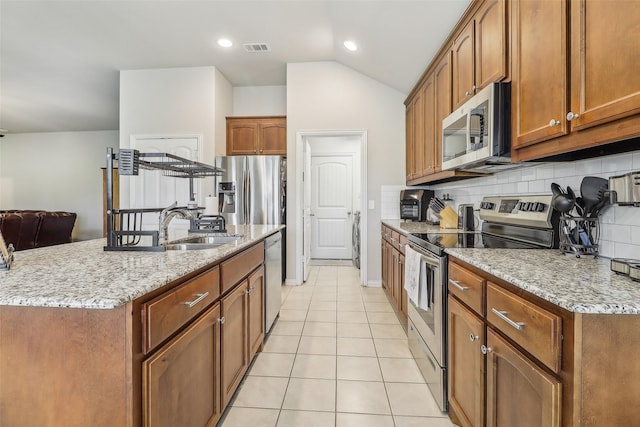 7203 Veal Station Rd, Weatherford, TX 76085 - kitchen featuring visible vents, appliances with stainless steel finishes, a sink, backsplash, and light tile patterned floors