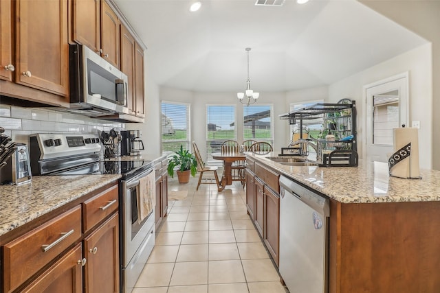 7203 Veal Station Rd, Weatherford, TX 76085 - kitchen with light tile patterned flooring, a notable chandelier, tasteful backsplash, appliances with stainless steel finishes, and visible vents